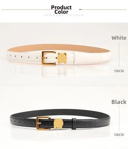 Close-up of black and white leather belts with gold buckles and fine stitching details