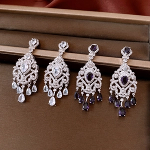 Detailed macro view of long tassel flower earrings with zircon in a jewelry box