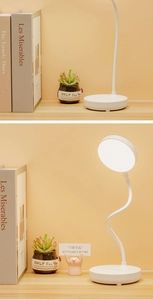 Detail of a minimalist white LED desk lamp with flexible 360-degree goose neck and round base
