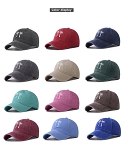 Matrix display of washed cotton baseball caps in twelve colors with palm tree embroidery