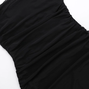 Detailed close-up showing the elegant ruched texture and sheer mesh fabric of the black dress