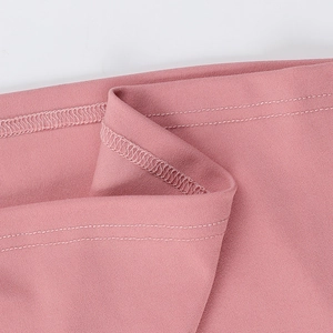Detail of pink fabric with white contrast piping and reinforced double-row stitching