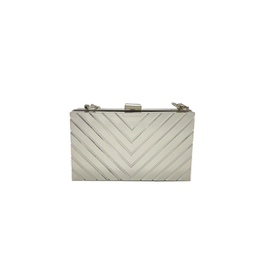 Detailed view of silver chevron texture on a rectangular metallic evening clutch bag