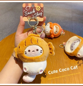 Detail of plush cat keychain with golden metal hook and soft snack shop design