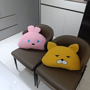 Detail of plush animal pillows in teddy fleece featuring cute rabbit and cat embroidery