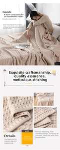 Detailed close-up of beige waffle weave cotton blanket with neat edge stitching