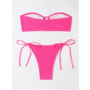 Detail of rose pink textured bandeau bikini set showing seersucker fabric and side ties