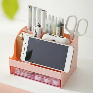 Pink desktop organizer with multi-compartment slots and transparent drawer for stationery