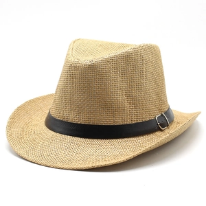 Classic straw western cowboy hat with black leather band and silver buckle on white background