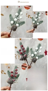 Detail view of artificial pine branches with snow, pine cones and red berries for Christmas