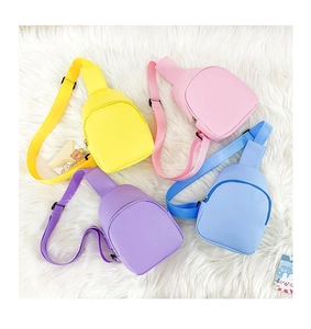 Detailed view of colorful PU leather toddler chest bags in pink, blue, yellow, and purple