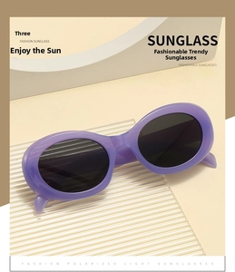 Detail view of purple oval polarized sunglasses on a modern geometric display stand