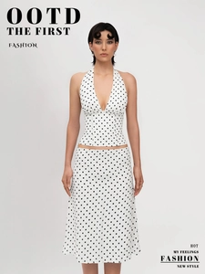 Detailed view of polka dot set featuring halter neck top and A-line midi skirt
