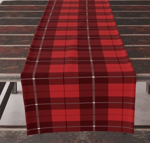 Close-up of red and black checkered table runner on a vintage dark wood dining table
