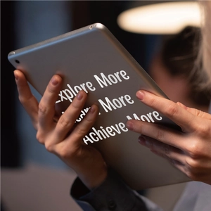 Detail of gray metal tablet back with Explore More, Learn More and Achieve More stickers