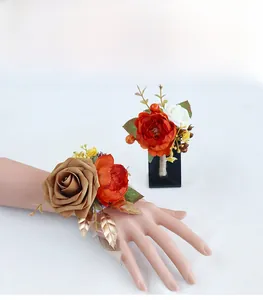 Detail of vintage coffee and orange wedding corsage and wristlet with golden berries