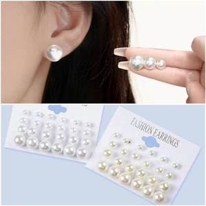 Close-up of 12-pair pearl earring set showing various sizes on model and packaging