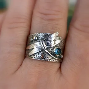Vintage oxidized silver dragonfly ring with textured band and round blue gemstone