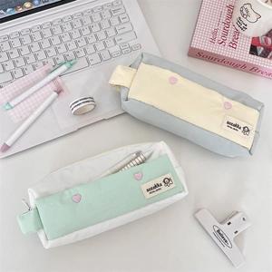 Detailed view of large capacity pencil cases with handle and cute heart decorations