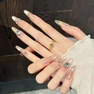 Handmade almond press-on nails with nude pink gradient, gold glitter and luxury rhinestones