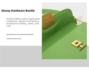 Detailed macro view of the light gold metal buckle on a green leather shoulder bag