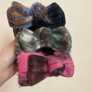 Three elegant flocking bow hair clips in autumn winter colors with soft fuzzy texture