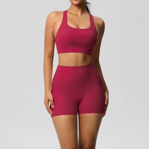 Detail view of red yoga set with pockets on shorts and breathable brushed sports bra