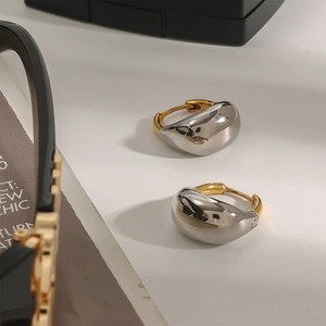 Two-tone 18K gold and silver stainless steel chunky teardrop hoop earrings on white