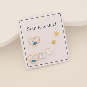 Detail of stainless steel earring set with evil eye heart and cubic zirconia studs