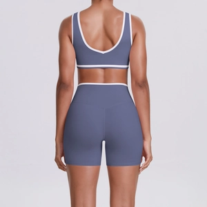 Close-up of contrast white piping on the back of yoga set sports bra and shorts