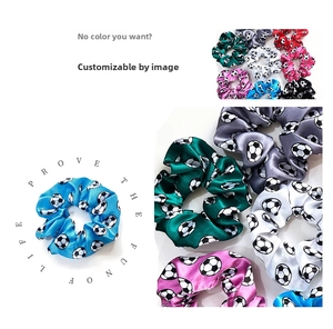 Macro shot of colorful satin football print scrunchies showing glossy silk texture