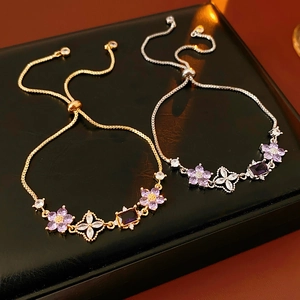 Detail of adjustable flower bracelet with purple zircon stones on black display box
