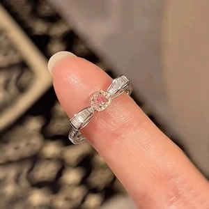 Detail of pink diamond bow ring with rectangle side stones on silver band