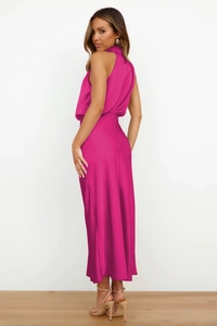 Detail of elegant backless satin dress in fuchsia with high-gloss finish and slim fit