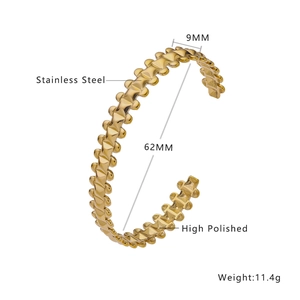 Macro detail of high polished golden stainless steel cuff bracelet with textured surface