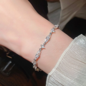 Close-up of a sparkling silver zircon bracelet with marquise-cut stones on a wrist