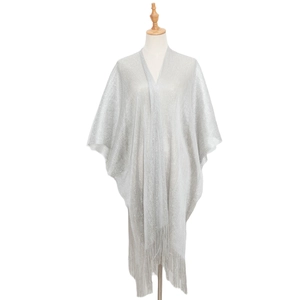Detail of silver metallic thread texture and elegant fringe tassels on the shawl