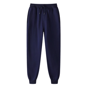 Detail of dark blue fleece jogger pants with adjustable drawstring and ribbed cuffs
