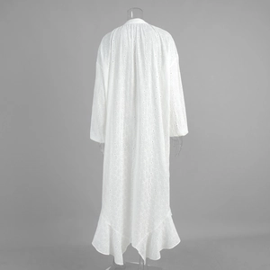 Detail of white cotton eyelet lace embroidery and ruffled hem on summer dress