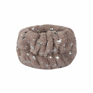 Close-up of brown plush headband with silver foil stars for spa and skincare