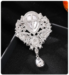 Macro shot of silver crystal brooch back showing the safety pin and hollow base