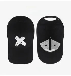 Detail view of the black cotton baseball cap showing X embroidery and inner sweatband