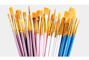 Detailed macro view showing assorted blue painting brushes with golden ferrules and nylon hair
