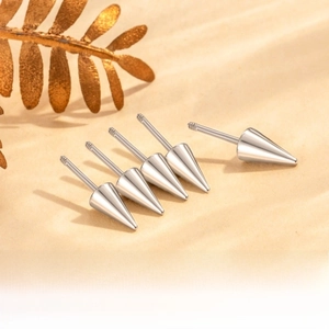 Detail of 0.8mm titanium steel piercing studs with screw thread and cone ends