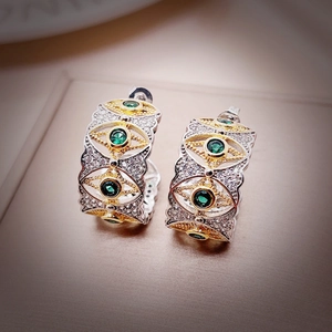 Two-tone gold and silver hoop earrings with green emerald stone and evil eye star motif