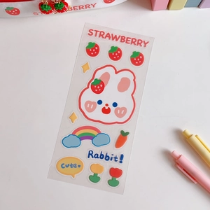Close-up of cute strawberry and rabbit PVC stickers for journal and cup decoration