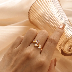 Detail of floral butterfly ring with pink and purple zircon stones on hand