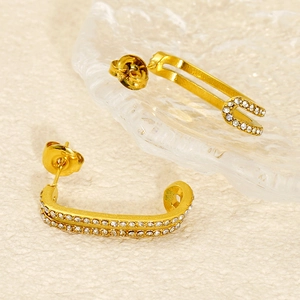 Macro shot of gold double-layer U-shaped earrings with micro-pave white zircon stones