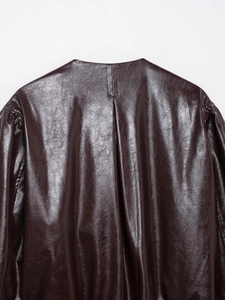 Detail view of the high-quality deep burgundy faux leather texture on bomber jacket back