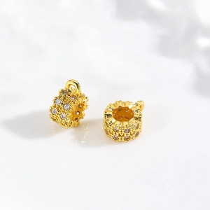 Macro detail of gold-plated cubic zirconia cylinder beads for DIY jewelry making